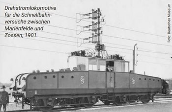 Schwarz-weiß Bild der Drehstromlokomotive, links daneben ein Mann