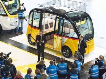 Das gelb-schwarze Schweizer Post-Shuttle, ein automatisiertes Fahrzeug, das aussieht wie ein kleiner Bus mit ca. 6 Sitzplätzen
